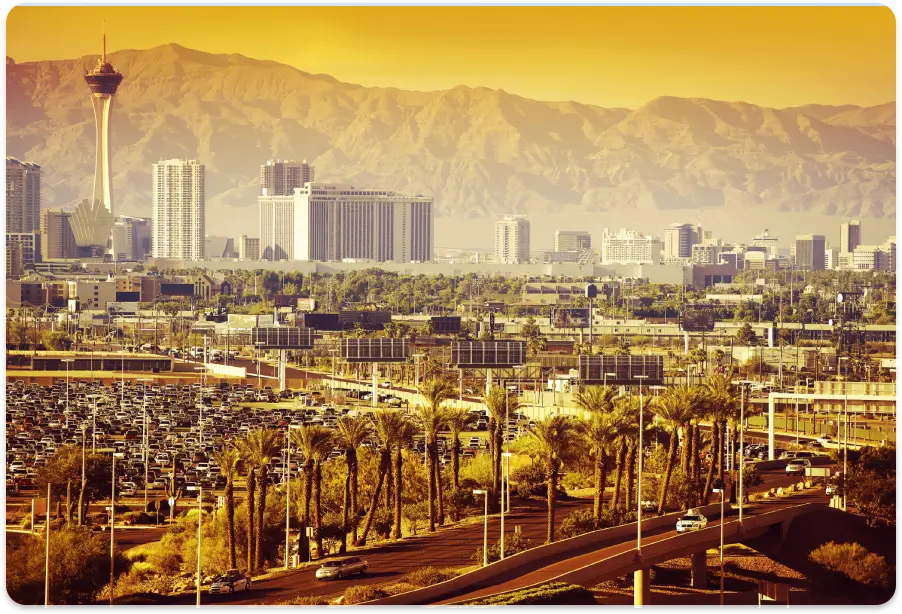 A view of palm trees and mountains in the background.